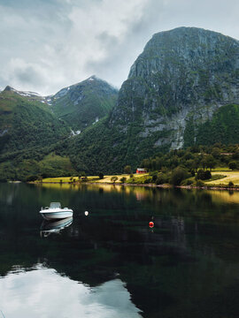 Norway scenery - lake Eikesdalsvatnet and boat with mountains reflection in the water landscape tranquil scenic nature view of More og Romsdal, summer season travel destinations in Scandinavia