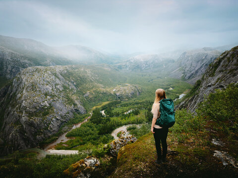 Woman with backpack hiking solo in Norway explore Rago park foggy mountains travel healthy lifestyle sustainable eco tourism freedom active adventure summer vacations trip outdoor traveler enjoy view