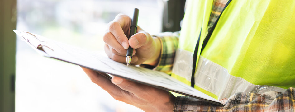 Building inspection asian contractor young man, male inspecting home, reconstructed construction, renovation or check defect, before finish handing it over to client, customer. Engineering worker.
