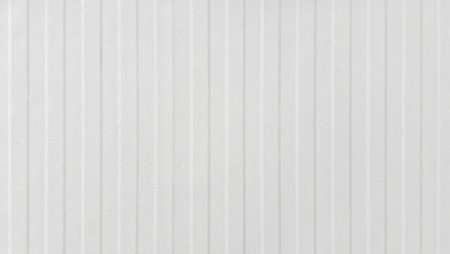 White corrugated metal sheet with uniform vertical stripes, clean minimalist texture ideal for industrial backgrounds, architecture, exterior siding, and seamless modern design