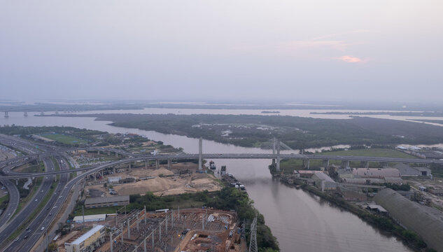 Aerial view of the cable-stayed bridge over the Guaiba River with highway interchanges and industrial surroundings in Porto Alegre, Rio Grande do Sul, Brazil.