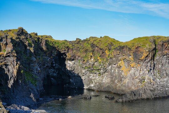 A picturesque cliff coastline between the villages of Hellnar and Arnarstapi in western Iceland.