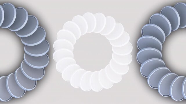 mesmerizing animated optical illusion of white circles arranged in ring in center of screen with two grey circles on either side, all moving in counterclockwise motion.