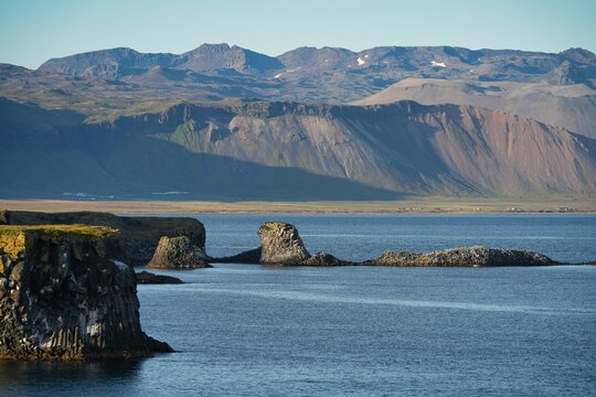A picturesque cliff coastline between the villages of Hellnar and Arnarstapi in western Iceland.