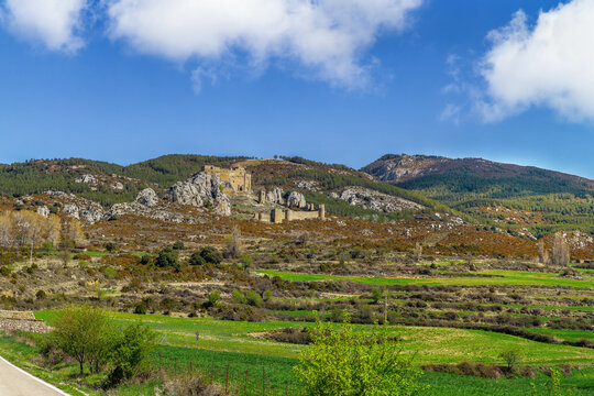 Castle of Loarre in Aragon, Spain, distant panoramic view. Historic romanesque fortress with surrounding mountain landscape