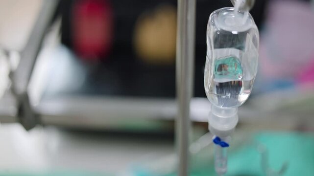 Close up of hanging IV fluid bag in hospital room