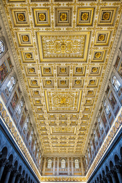 Perspective view looking up at the grand gilded coffered ceiling and nave of the Basilica of Saint Paul Outside the Walls in Rome Italy
