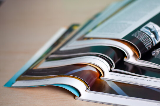 Stack of magazines on wood table