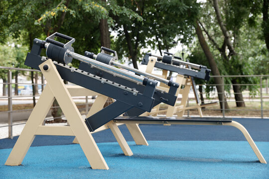 Modern chest press machine in outdoor gym at park