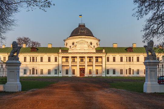 Beautiful symmetric view of an old antique palace mansion with lion sculptures at sunset