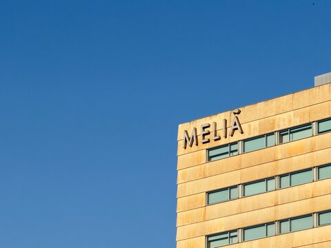 Palma, spain, august 2, 2026, melia hotel building facade with corporate sign under clear blue sky, architecture exterior showing windows and logo