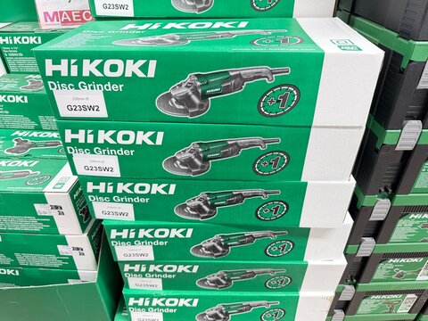 Palma, spain, august 2, 2026, hikoki disc grinder g23sw2 power tools in green packaging boxes stacking on display shelves