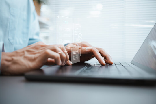 Hands type on a laptop beneath TAX and INVOICE graphics while arranging each digital document for tax filing and preparing payment details for a secure electronic archive before review.