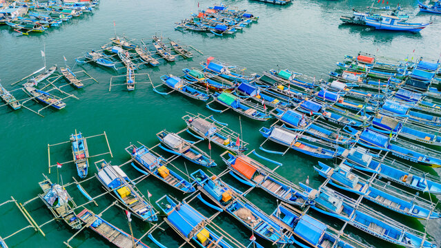 Aerial view of numerous traditional fishing boats moored in the harbor of Palabuhanratu, West Java, Indonesia.
