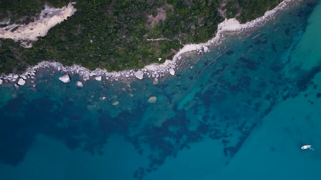 Top Down Aerial View Of Turquoise Sea And Rocky Coastline Near Afionas In North Corfu Greece