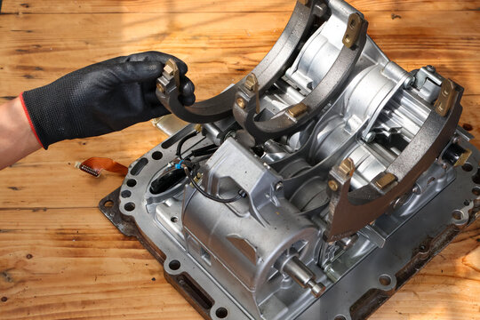 Mechanic Hand Checking Shift Fork on Transmission Mechatronic Unit.