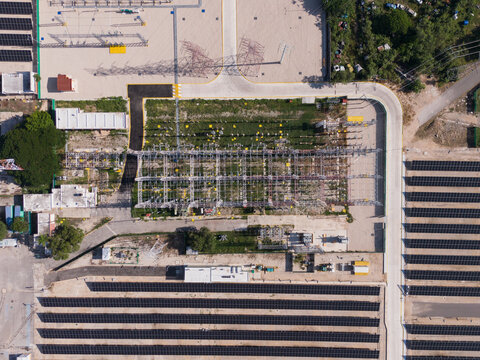 Aerial view of the CFE Merida Area electrical substation featuring rows of solar panels, high-voltage power lines, and industrial infrastructure in Merida, Yucatan, Mexico.