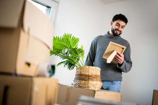 Man carrying a cardboard box while moving household belongings