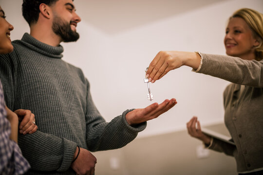 Couple receiving a house key during property handover