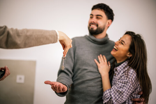Couple receiving a house key during property handover