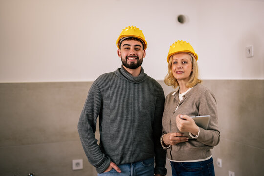 Construction professionals posing together during a renovation project