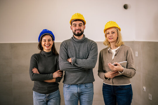 Construction team standing together during an indoor renovation project