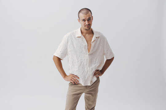 Funny Skeptical Young Man Standing Hands on Hips with Doubtful Expression