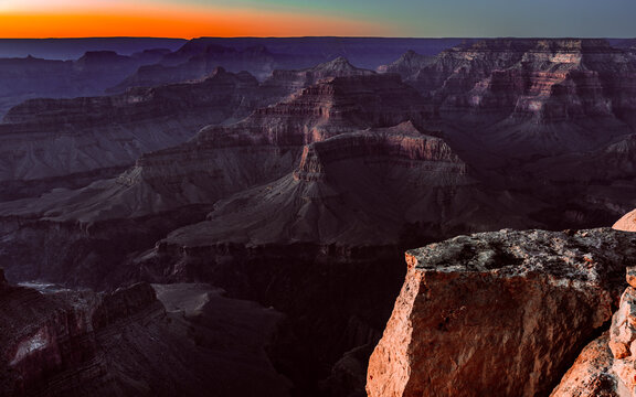 Grand Canyon Layered Ridges at Sunset with Glowing Orange Horizon, Arizona Landscape