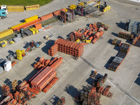 Aerial view of the PERI Polska Sp. z o.o. facility, featuring stacks of orange construction formwork and scaffolding components in a paved yard in Jaworzno, Silesian Voivodeship, Poland.
