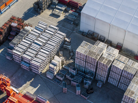 Aerial view of PERI Polska Sp. z o.o. facility with stacks of construction scaffolding, formwork panels, and metal components in an industrial yard in Jaworzno, Wojewodztwo slaskie, Poland.