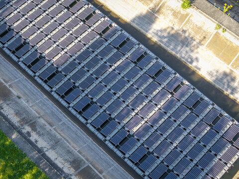 Aerial view of floating solar panels arranged in rows on a water surface in Poland.