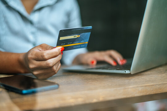 Woman Making Online Payment with Credit Card and Laptop