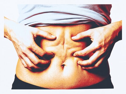 Person Holding Abdomen Expressing Stomach Pain and Bloating Discomfort