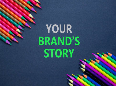 Branding and your brands story symbol. Concept words Your brands story on beautiful black paper. Beautiful black background. Colored pencils. Business branding your brands story concept. Copy space.