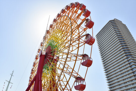 Colorful Ferris Wheel and Apartment Building at Port in Kobe, Japan
