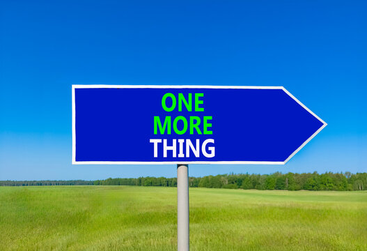 One more thing words symbol. Concept words One more thing on beautiful blue road sign. Beautiful blue sky green grass background. Business and one more thing concept. Copy space.