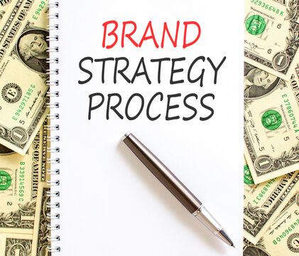 Brand strategy process words symbol. Concept words Brand strategy process on beautiful white note. Beautiful dollar bills background. Business and brand strategy process concept. Copy space.