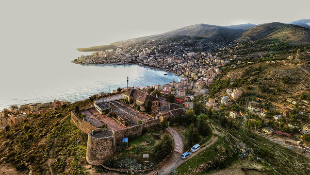 Aerial view of Lekuresi Castle overlooking the historic stone walls and the coastal city of Sarande, Vlore County, Albania.