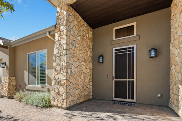 Fototapeta premium Stone pillar entrance with security door