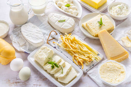 Assortment of dairy products including various cheeses, milk, and butter
