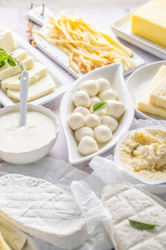 Assortment of dairy products including various cheeses, milk, and butter