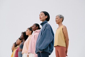 Obraz premium Diverse multigenerational women standing in line for wellness and empowerment banner background for active lifestyle design