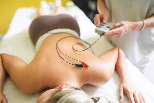 Relaxed Young Woman Receiving Acupuncture Treatment