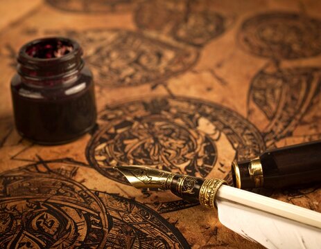 A quill feather antique pen and ink well in a retro vintage engraved or etched woodcut print style.
