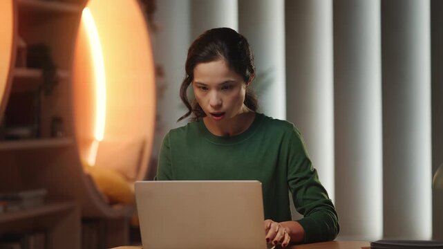 Young Korean female programmer has laptop problems and faces possible data loss