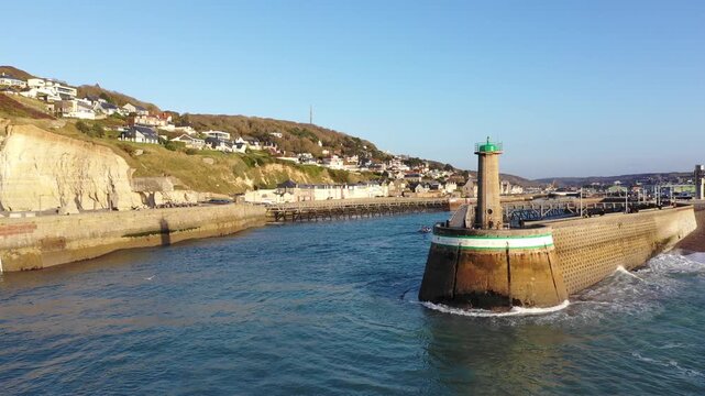 Aerial footage shows the iconic lighthouse and long pier at the entrance to the port of Fecamp, located on the Alabaster Coast in Normandy, France.