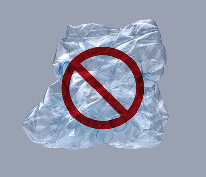 No plastic prohibition symbol over crushed bottles for pollution ban concept