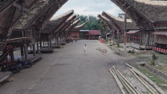 Tourist woman exploring traditional tana toraja village in indonesia