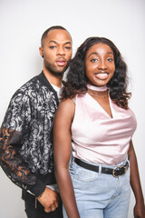 Obraz premium young adult american man and sister standing on white background with fashion clothes