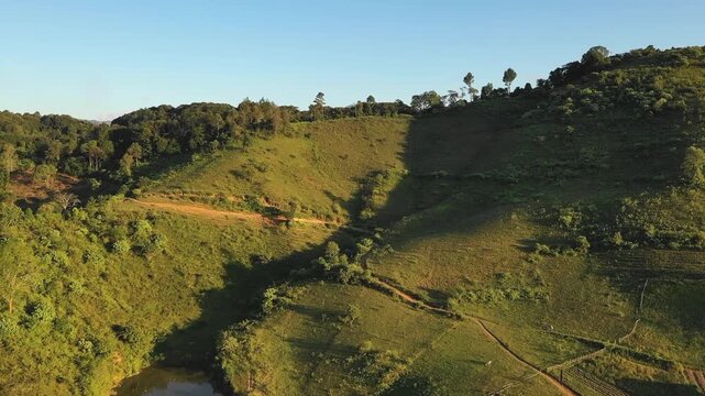 Drone footage capturing the lush green hills and forested slopes of the Mang But Pu Cha summit near Dien Bien Phu, Northwest Vietnam.